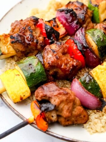 Grilled setian and veggies on kebabs over a bed of quinoa and drizzled with teriaki sauce.
