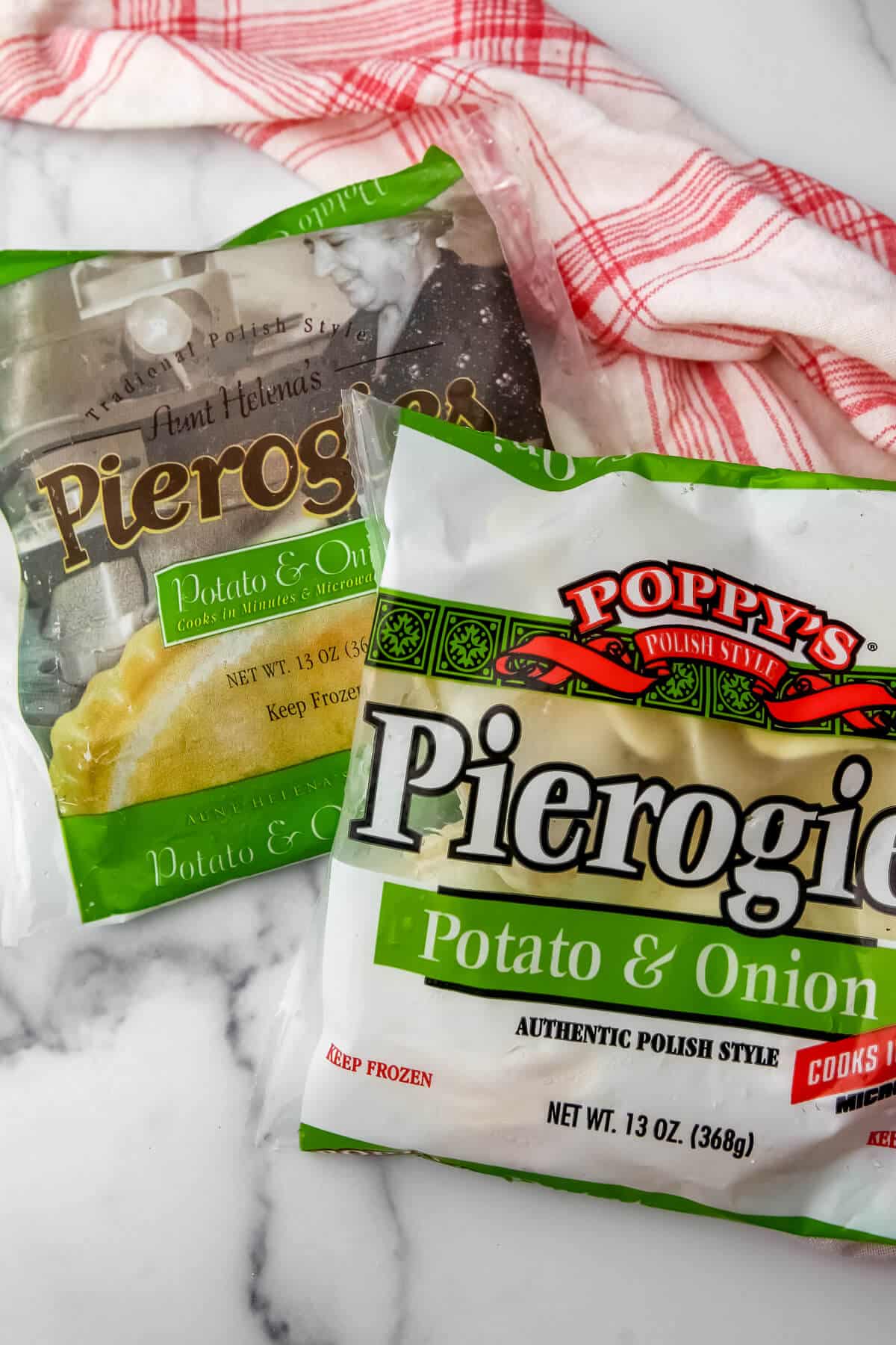 Two bags of frozen vegan pierogies on a countertop. 