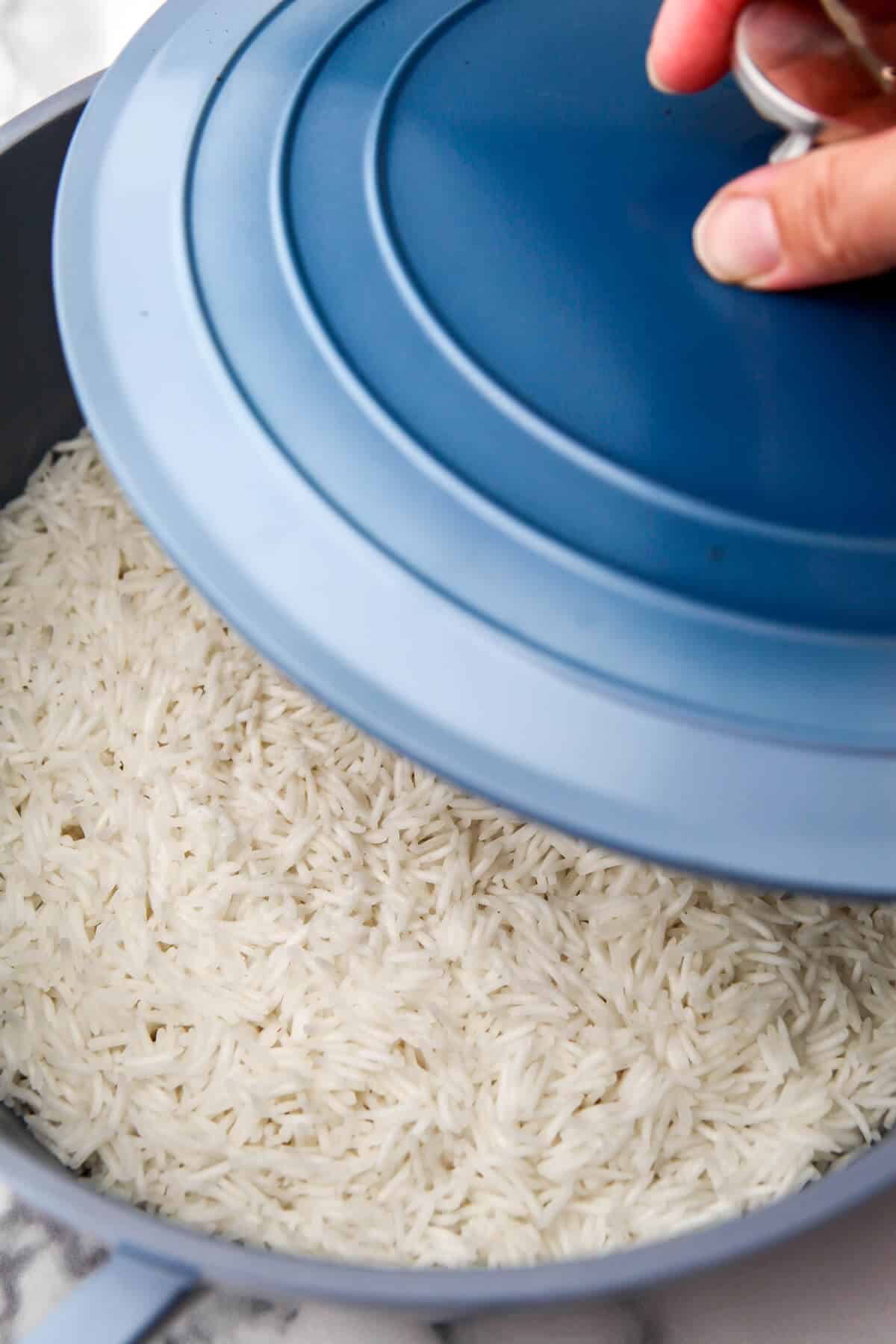 Placing a lid on rice during the cooking process.
