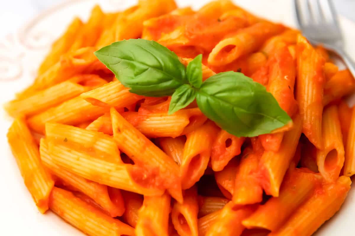 A close up of roasted tomato and pepper pasta.