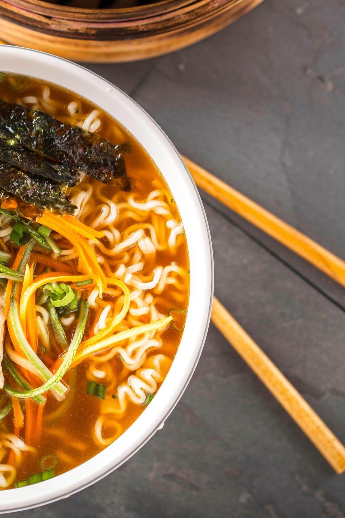 Ramen noodle soup with chop sticks on the side.