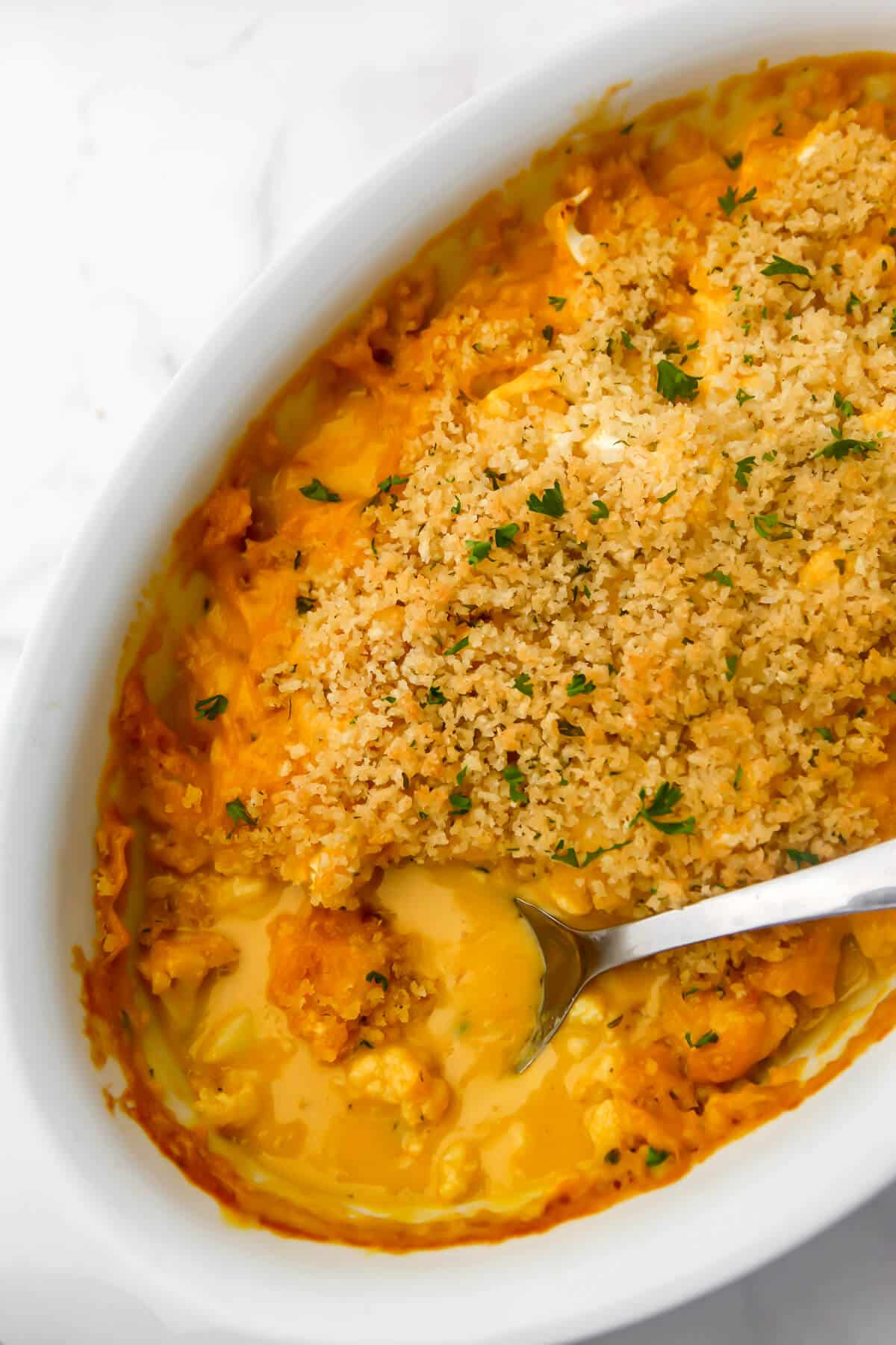 A top view of a baked dairy-free cauliflower bake with breadcrumbs on top.