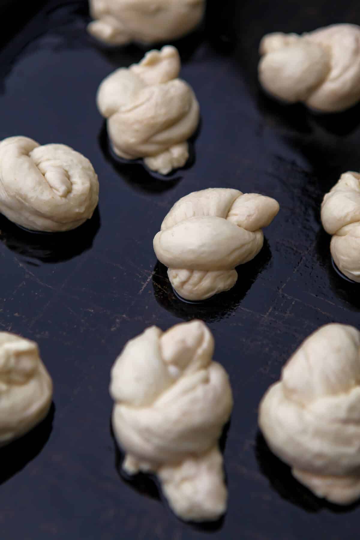 Dough knots on a baking sheet before baking.
