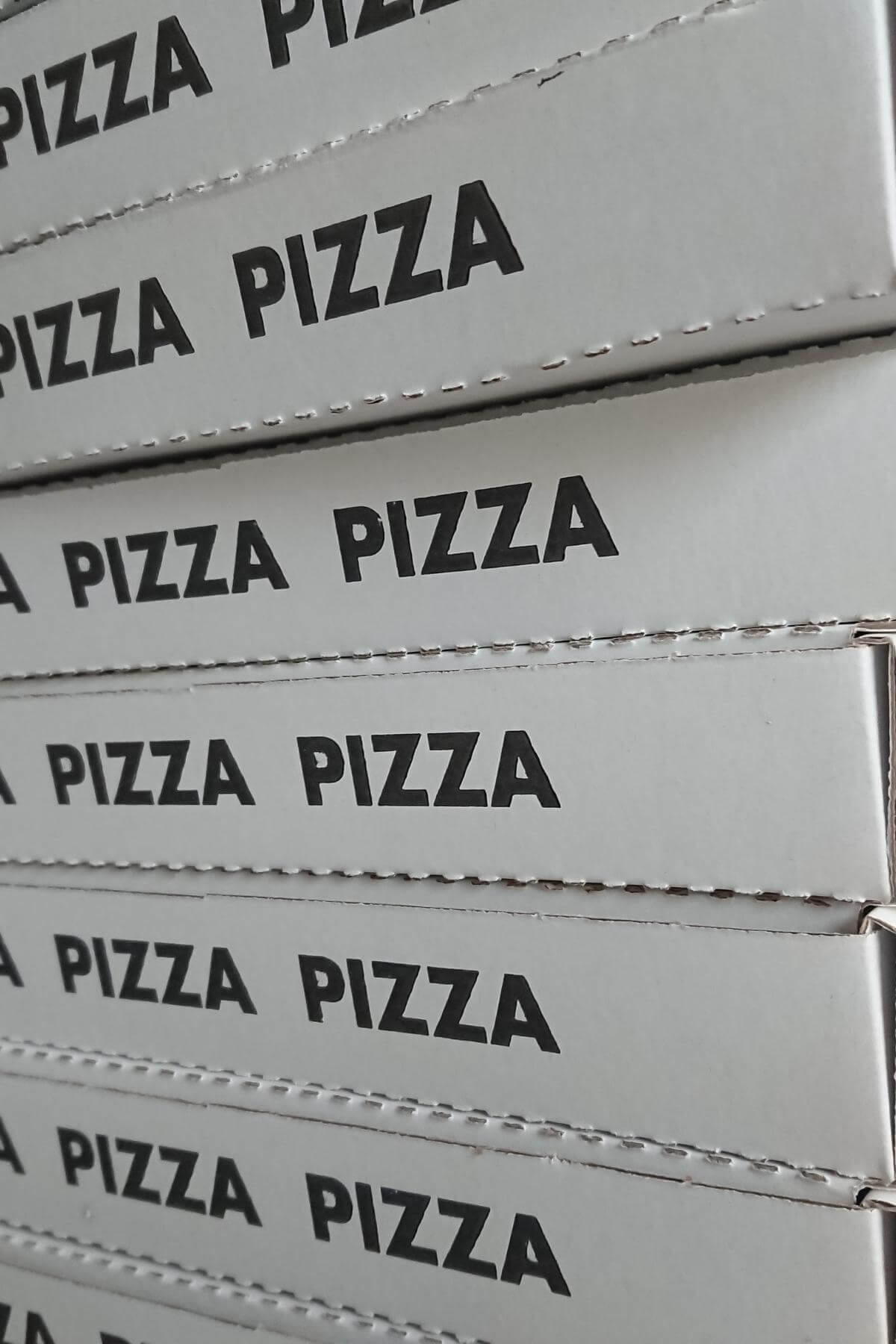 Pizza boxes stacked up.