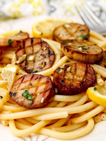 Vegan scallops made from king oyster mushrooms served over a bed of pasta.