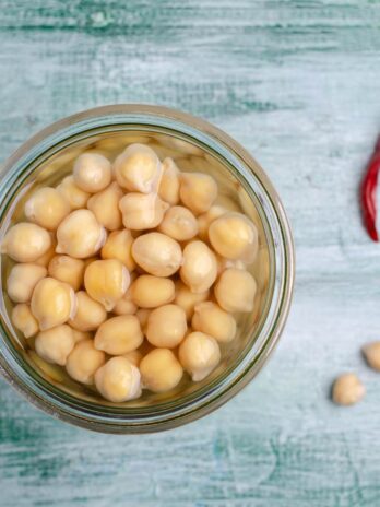 A jar of chickpeas with aquafaba in it.