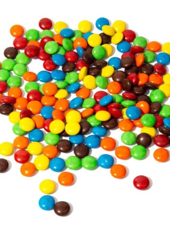 Colorful M&Ms on a white countertop.