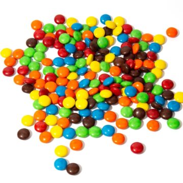 Colorful M&Ms on a white countertop.