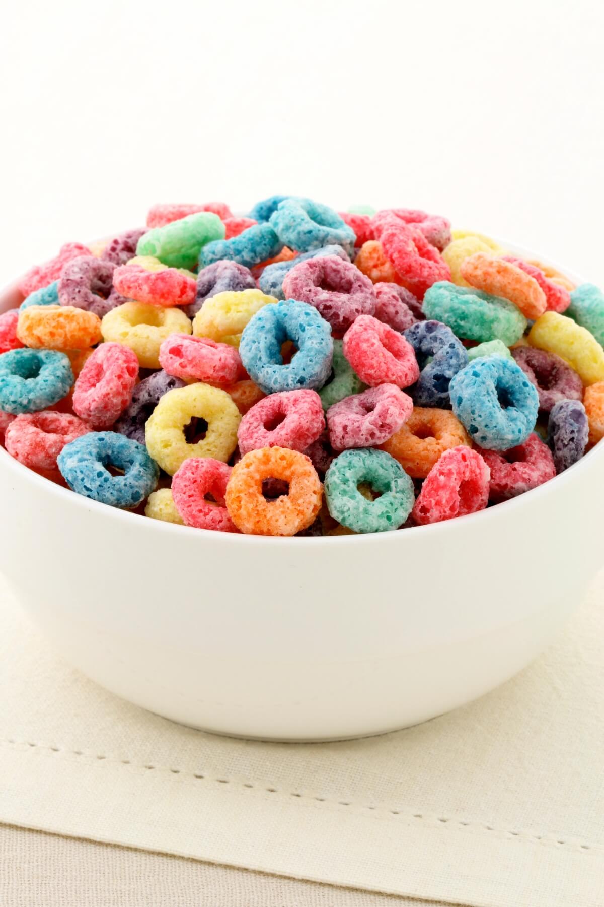 A bowl of fruit loops in a white bowl.