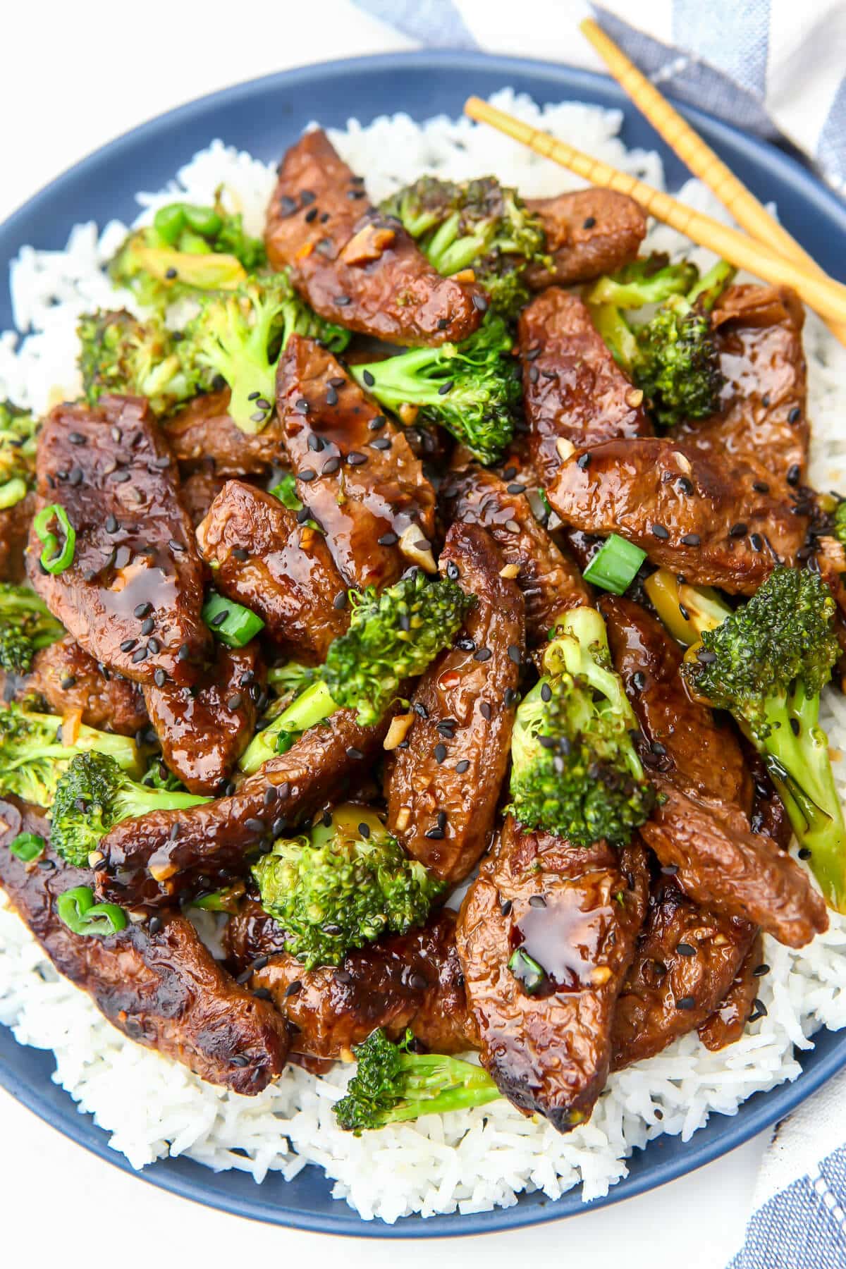Vegan beef and broccoli served on a blue plate.