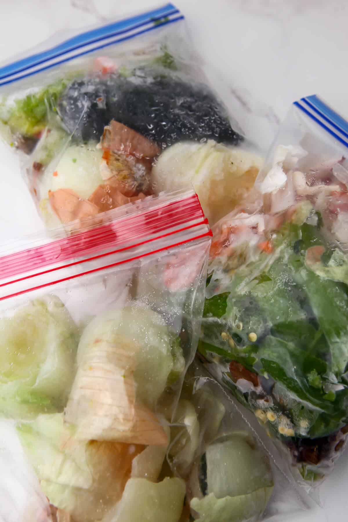 Freezer bags full of vegetable scraps to make broth.