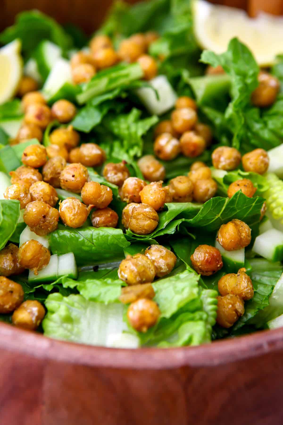A salad topped with sauteed chickpeas.