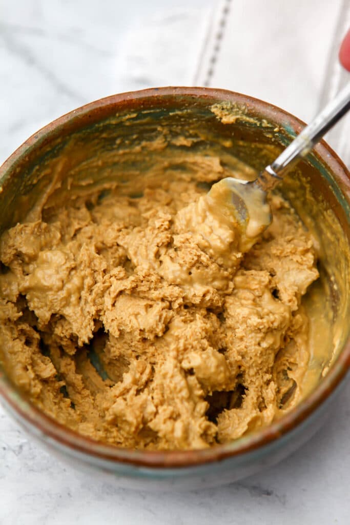 Tahini mixed with spices before water is added to make tahini dressing.