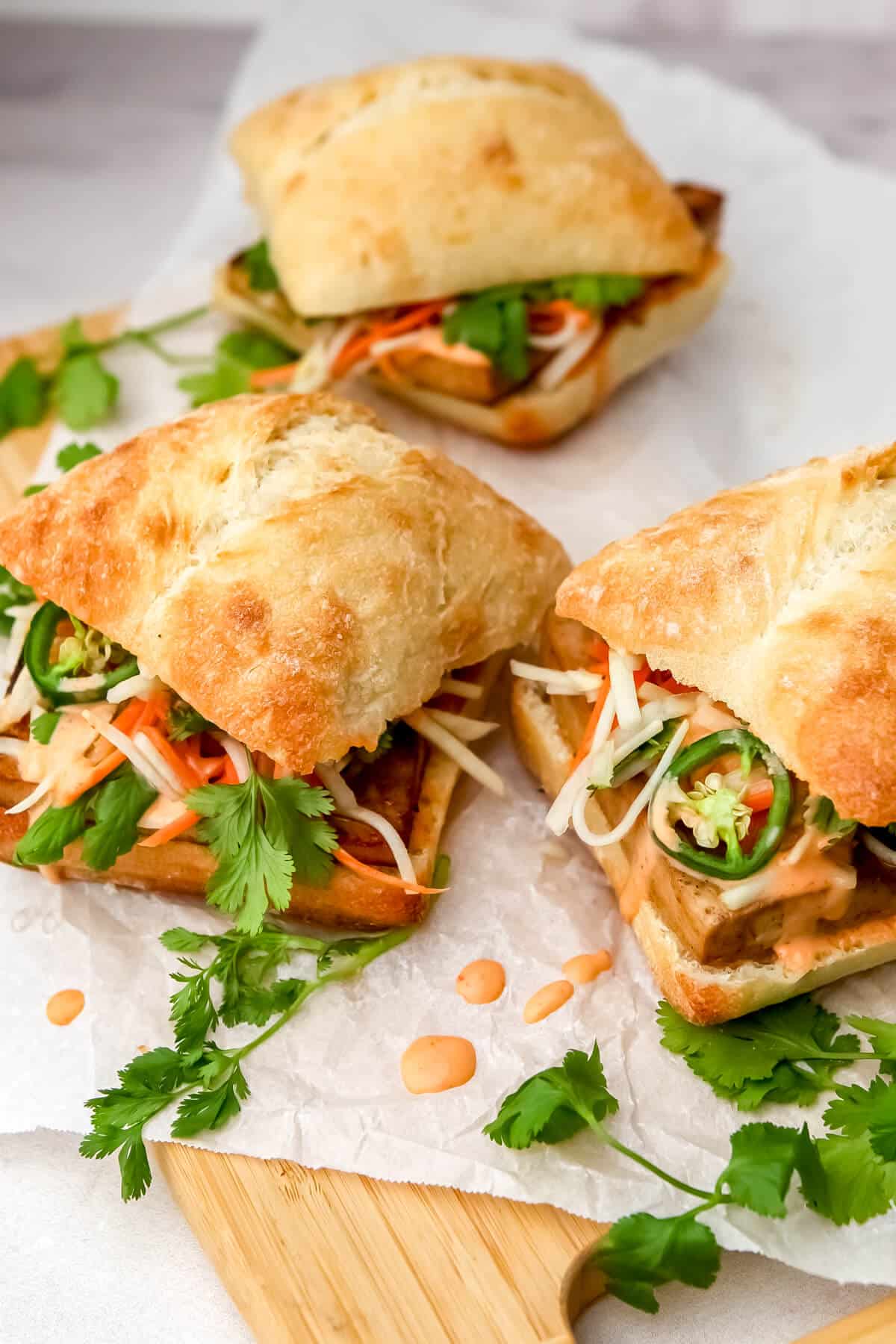 Tofu Bahn Mi sandwiches with pickled carrots, daikon, and vegan siracha mayo.