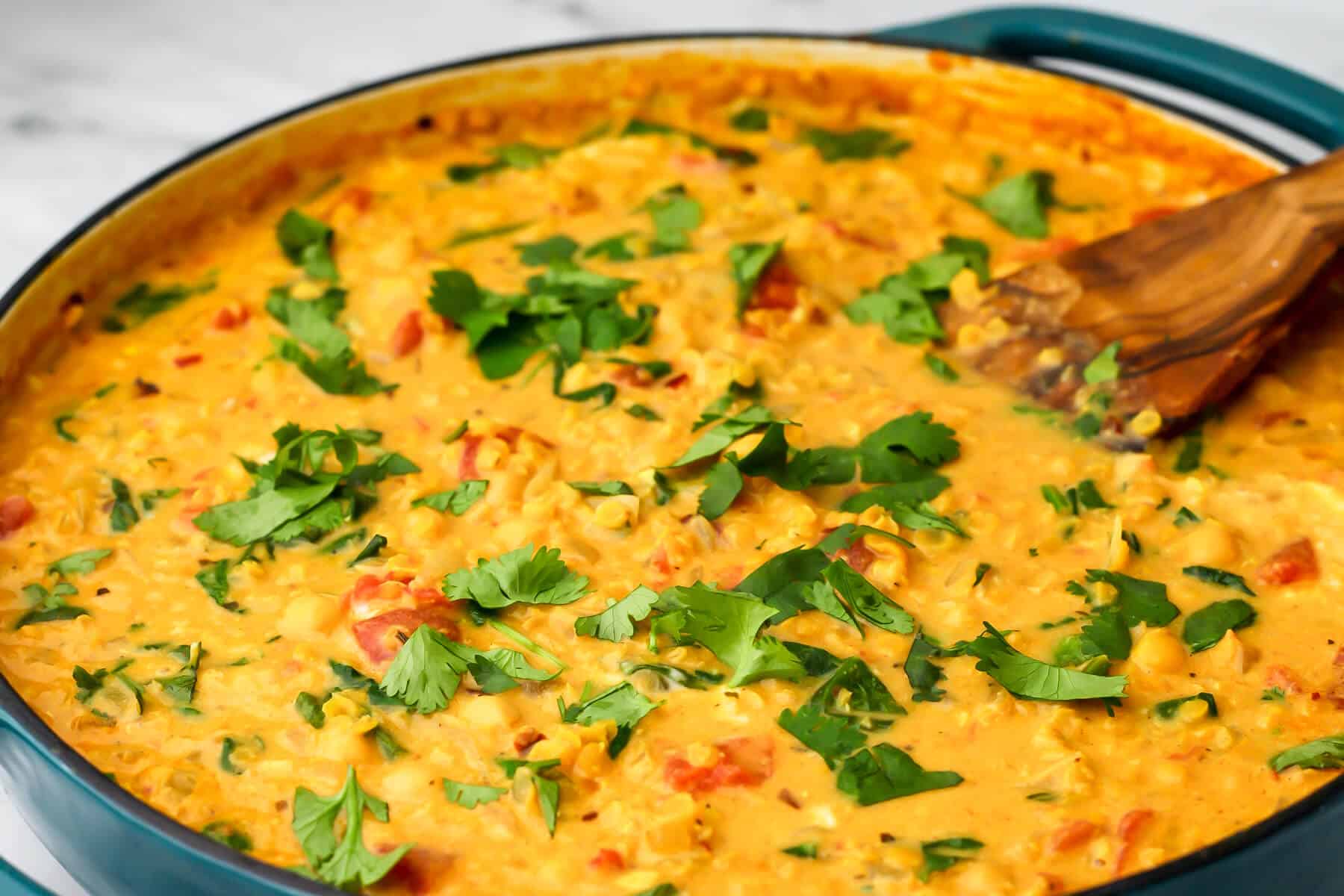 Red lentil curry in a a large  blue skillet.