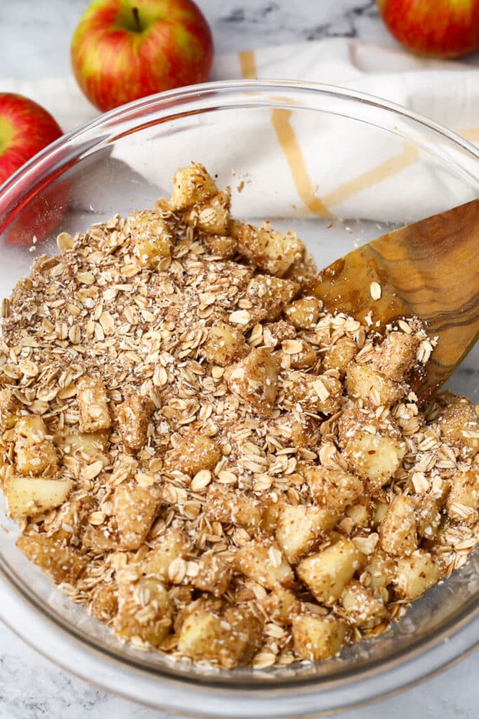 Diced apples added to oatmeal to make baked oatmeal.