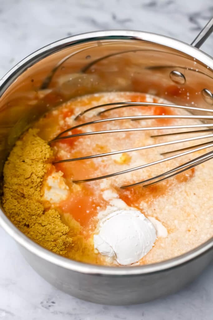 Vegan pumpkin alfredo ingredients in a pan before mixing and cooking.