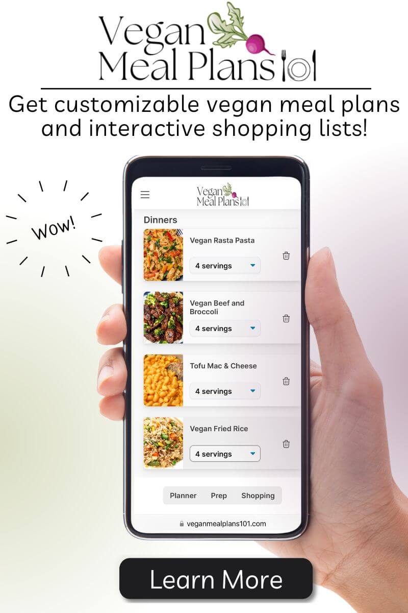An image of a person holding a cell phone with a vegan meal plan app on it.