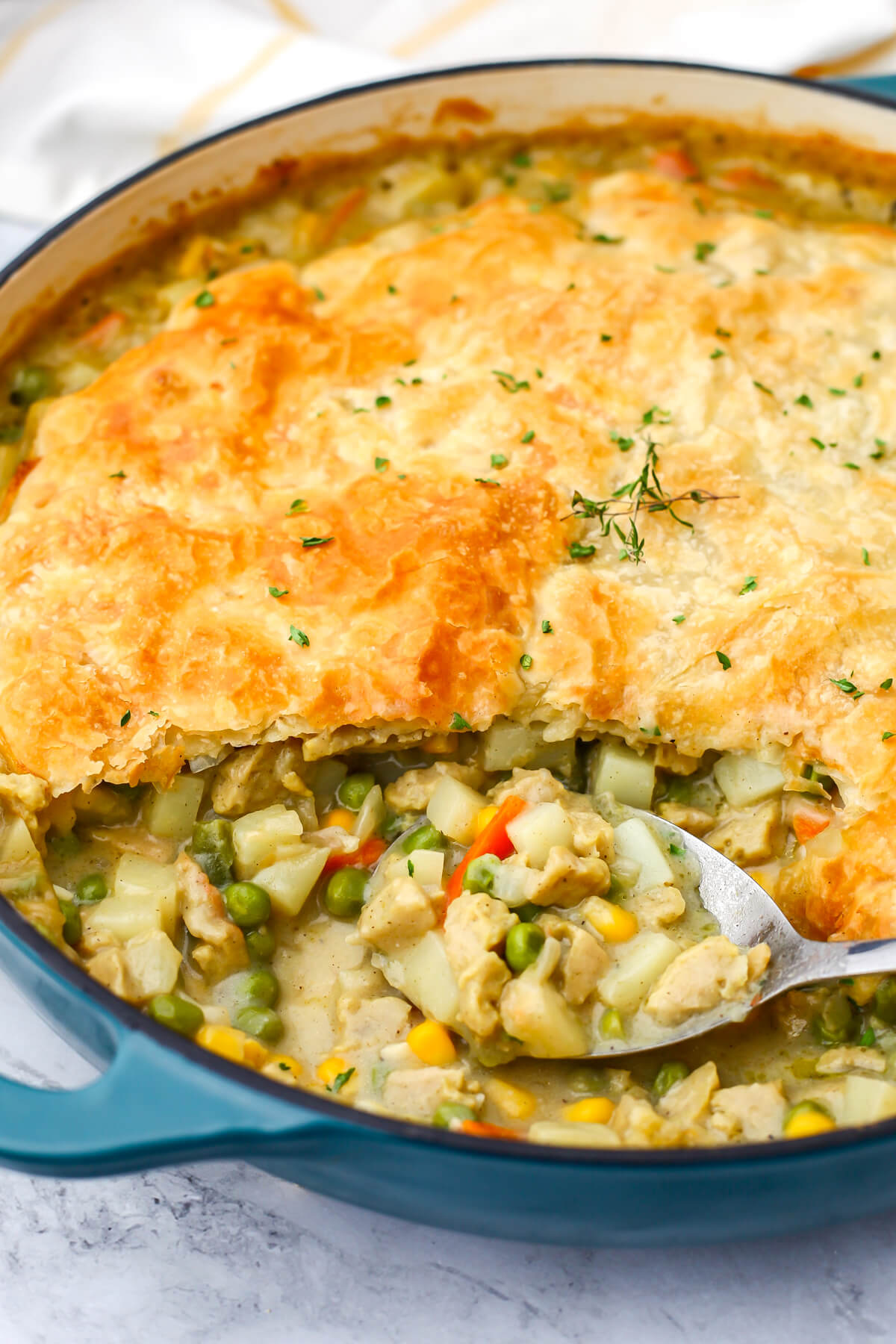 A close up of a vegan chicken pot pie with a scoop taken out of it.