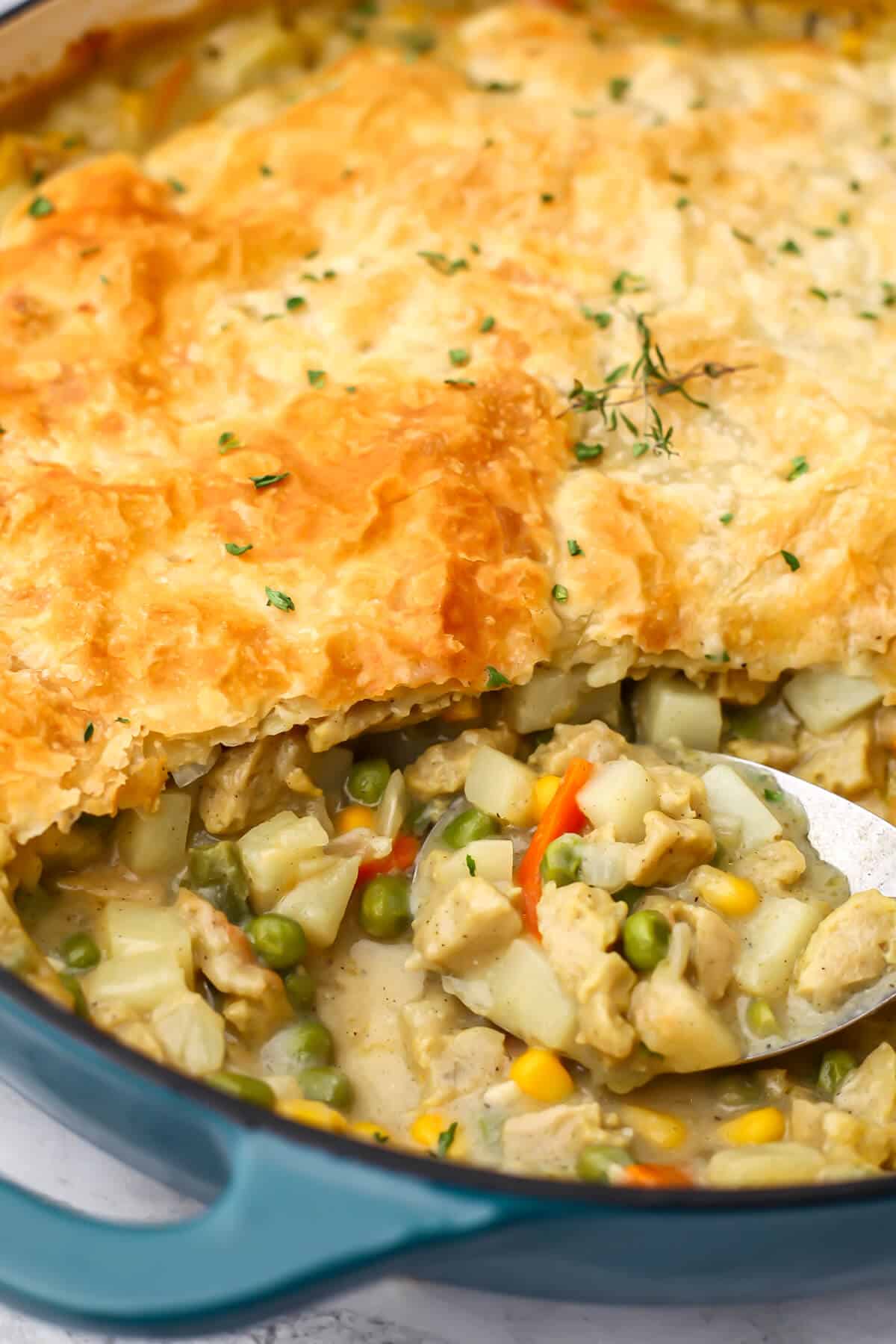 A close up of a vegan chicken pot pie with a scoop taken out of it.