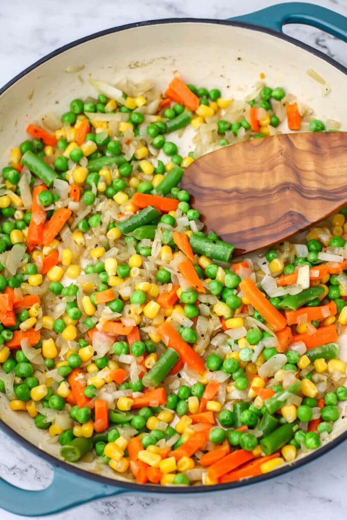 sauteed veggies in a skillet to make a vegan pot pie.
