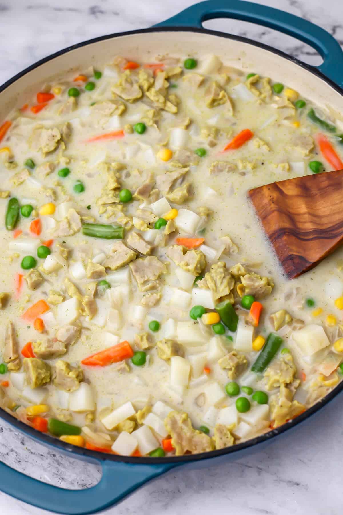 Potatoes, vegan chicken, and veggies in a sauce to make a vegan pot pie.