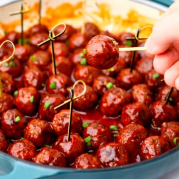 A large blue frying pan with vegan meat balls in a sweet and spicy meatball sauce.