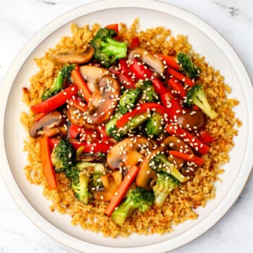 A vegetable stir fry with a vegan stir-fry sauce served over toasted quinoa.