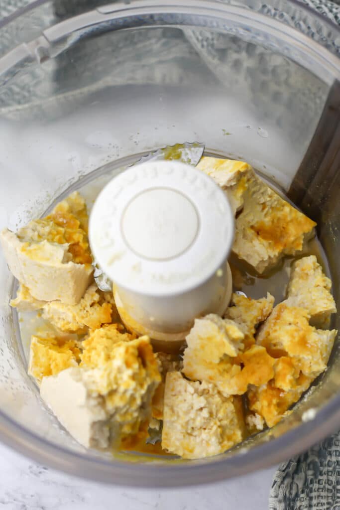 Tofu, refined coconut oil, nutritional yeast, apple cider vinegar, and salt in a food processor.