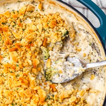 A top view of a vegan chicken broccoli casserole with a spoon in it.
