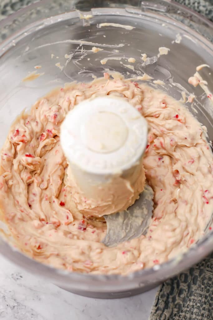 Vegan strawberry cream cheese blended in a food processor.