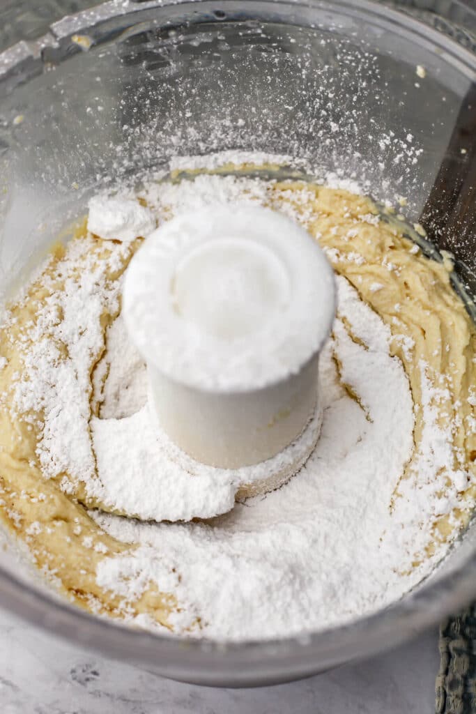 Powdered sugar added to tofu cream cheese in a food processor.