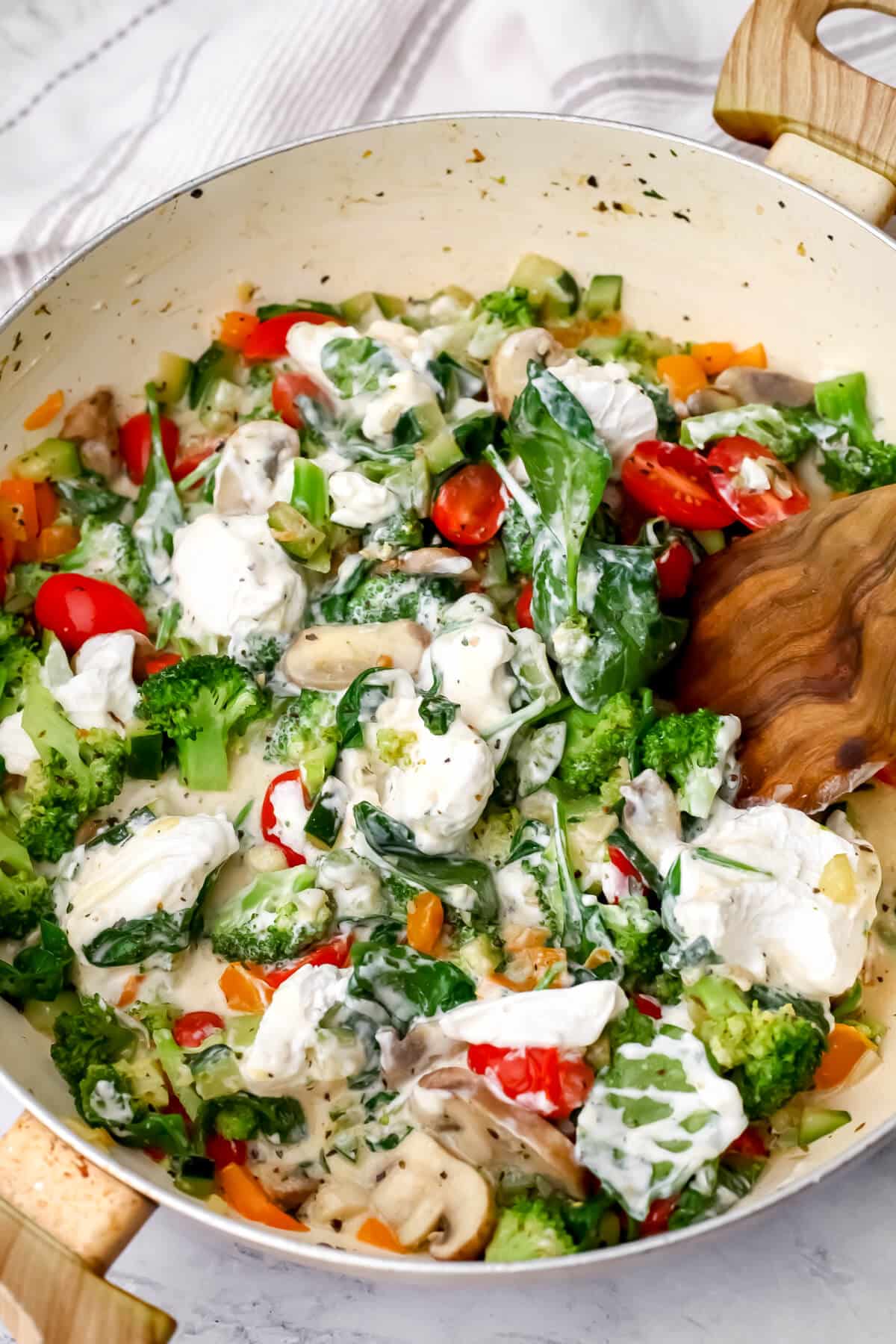 Vegan sour cream and pasta water added to sautéed veggies to make creamy pasta sauce.
