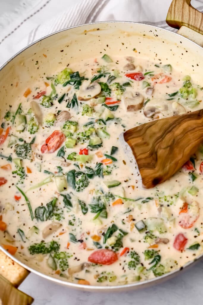 Creamy vegan vegetable pasta sauce in a wok.