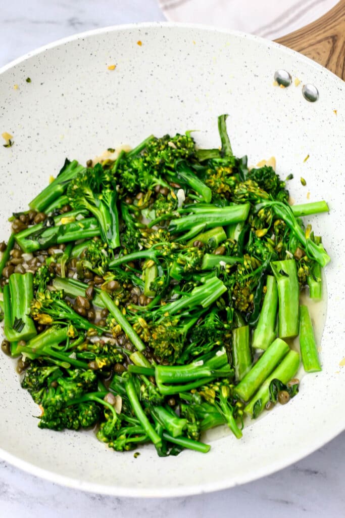 Broccolini in a white walk after it has been cooked.