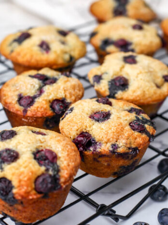 Blueberry Applesauce muffins on a black wire cooling wrack.