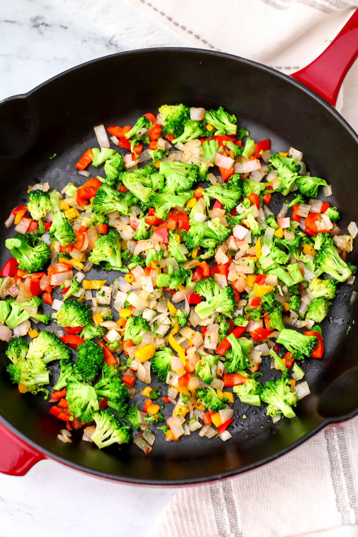 Finely chopped veggies in a skillet to make vegan egg bites.