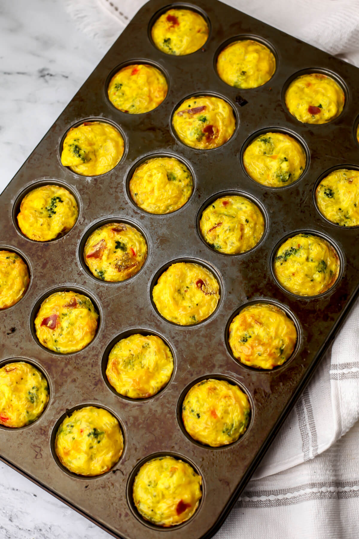 Vegan egg bites in a mini muffin tin after they have baked.
