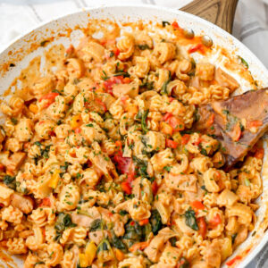 A skillet filled with vegan Cajun pasta with vegan chicken.