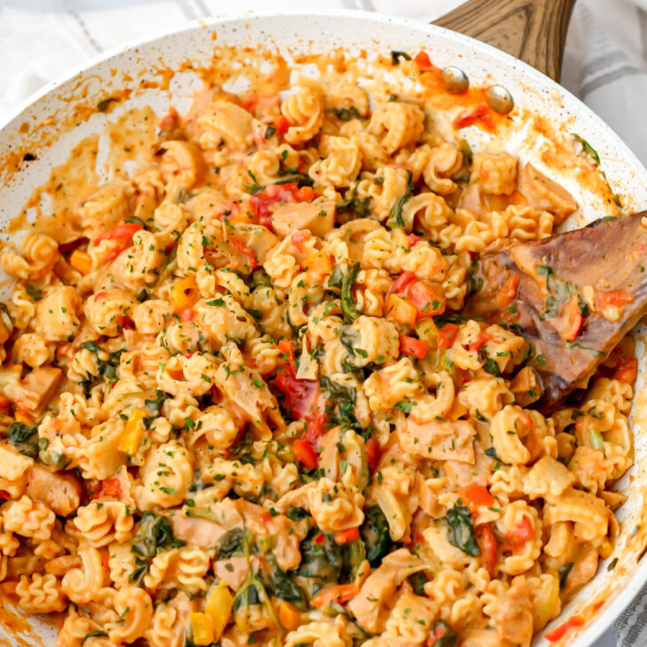 A skillet filled with vegan Cajun pasta with vegan chicken.