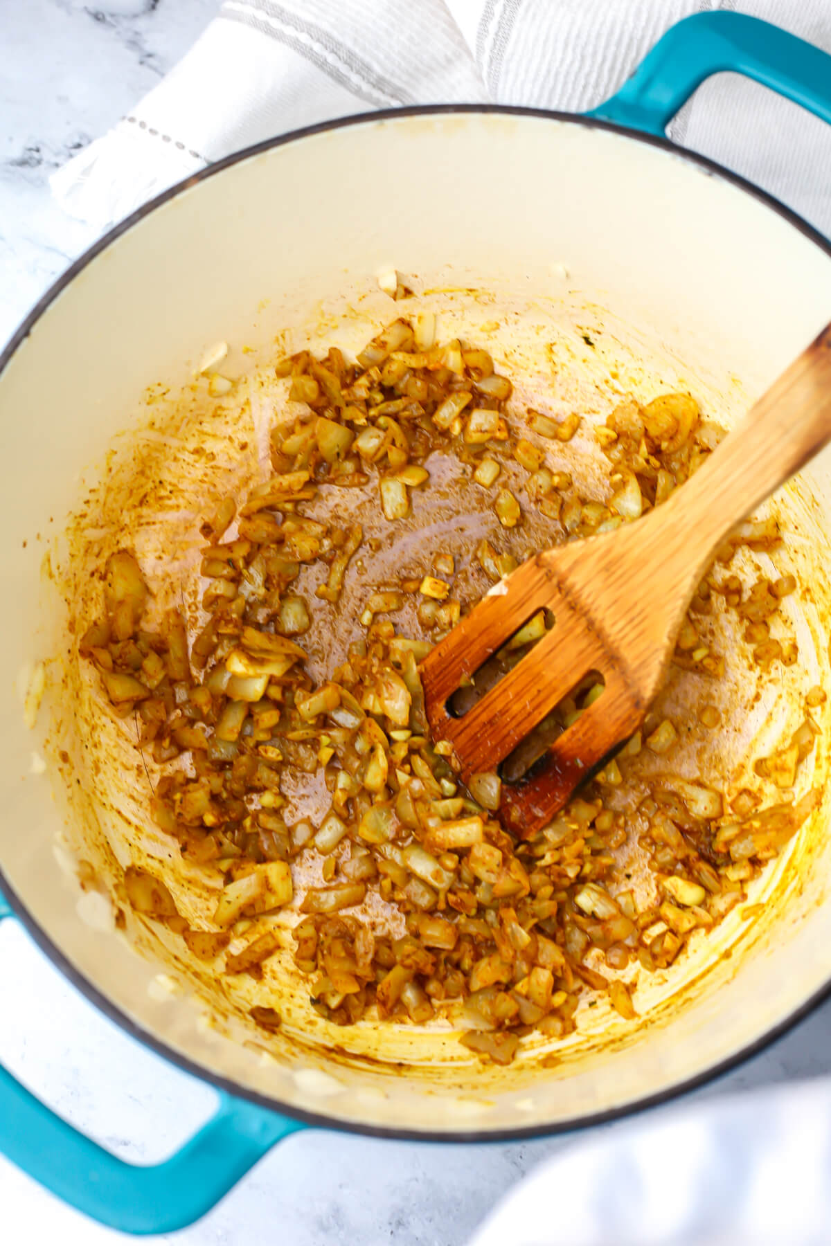 Sauteed onions, garlic, and spices to make curried cauliflower soup.