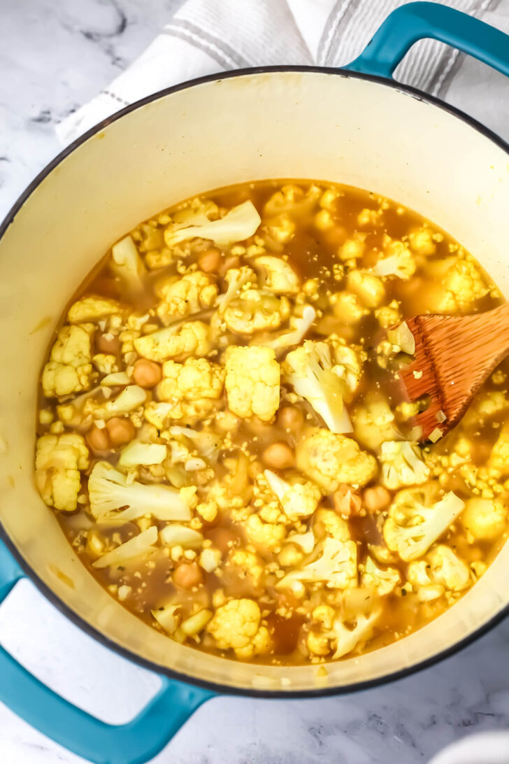 Cauliflower, chickpea, and broth added to the soup.