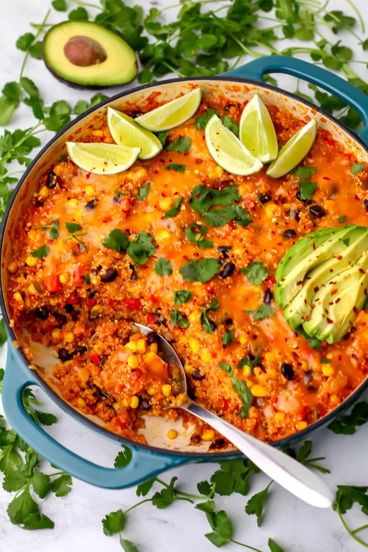 A top view of a blue skillet filled with vegan Mexican quinoa with corn and beans.