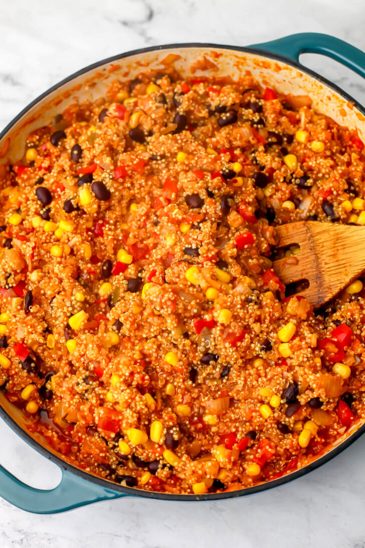 The vegan Mexican quinoa being stirred once cooked.