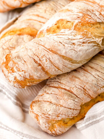 Four vegan French Baguettes on a tea towel.