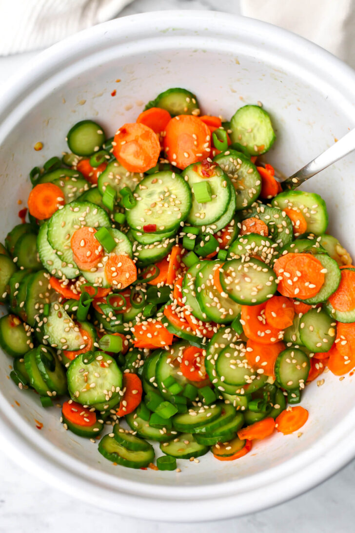 A top view of a cucumber tofu salad before the tofu is added.