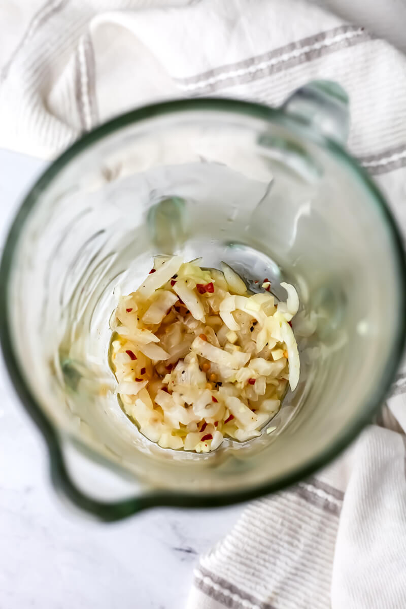 Sauteed onions and garlic added to a blender.