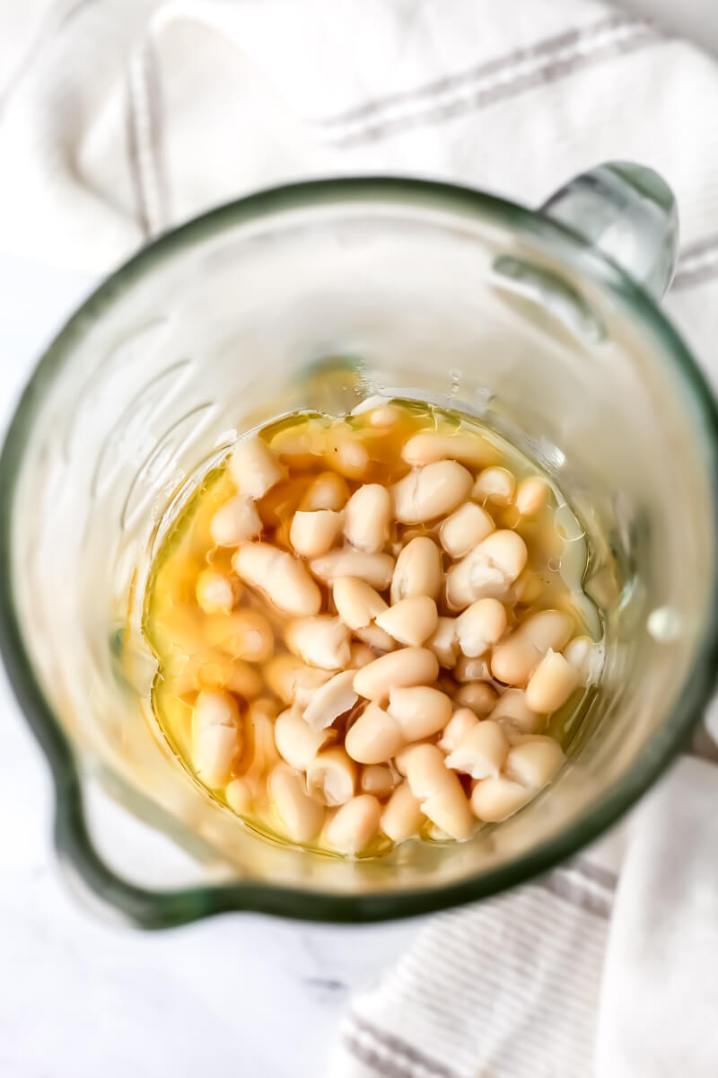 White beans and pasta water added to a blender with sauteed onions and garlic.