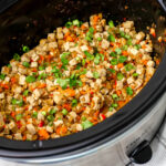 A slow cooker filled vegan lettuce wrap filling made with tofu and veggies.
