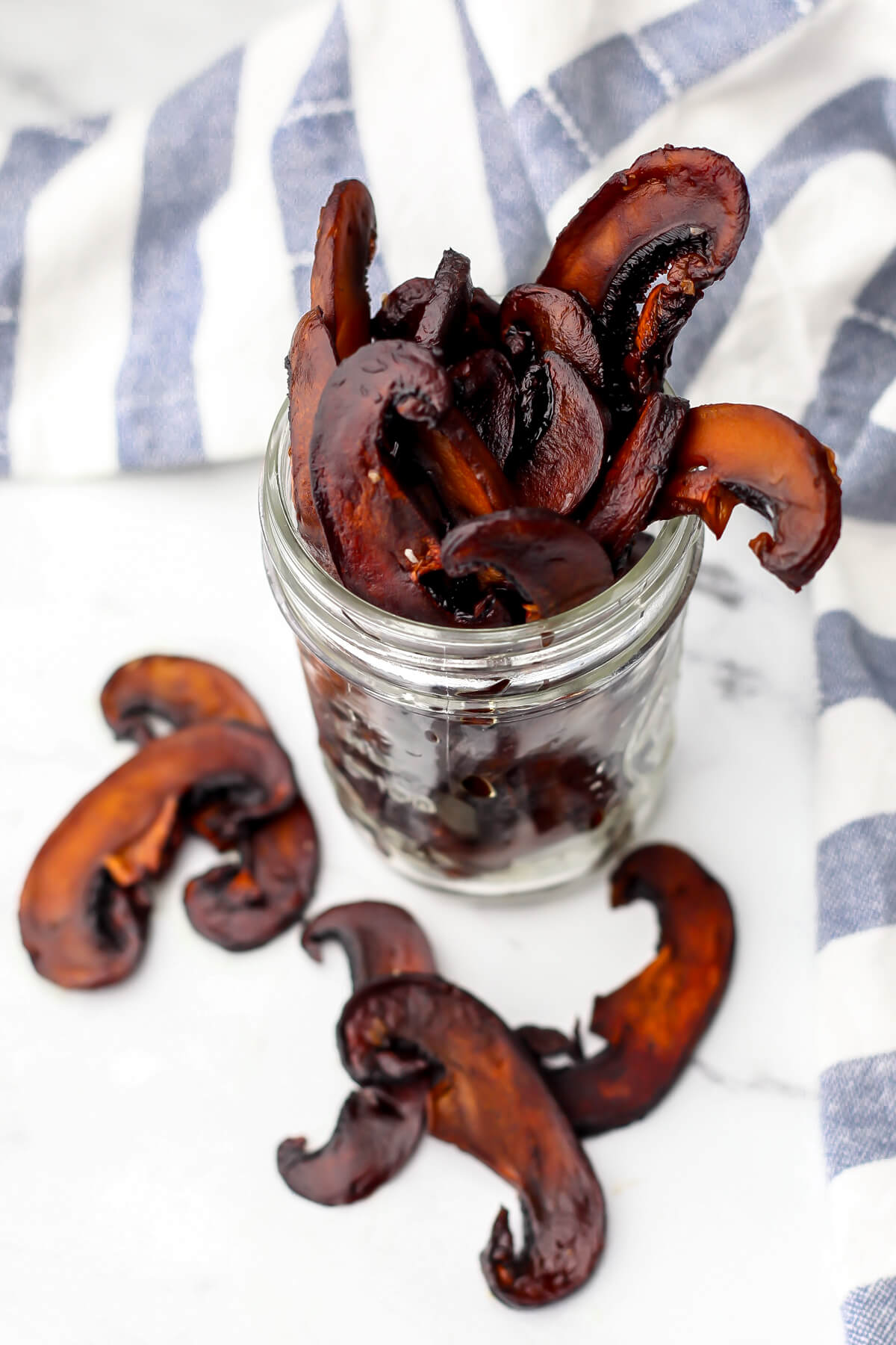 A top view of a jar of portobello mushroom jerky.